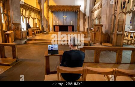 ERNEUTER WEGGANG DER FREMDEN ZEILE AM UNTEREN RAND DER BILDUNTERSCHRIFT EIN Gemeindemitglied der Kirche beobachtet einen Laptop in der Liverpool Parish Church (Our Lady and St Nicholas) in Liverpool während des ersten virtuellen Sonntagsgottesdienstes der Kirche von England, den der Erzbischof von Canterbury Justin Welby gegeben hat, Nachdem die Erzbischöfe von Canterbury und York am Dienstag an Geistliche geschrieben hatten, um ihnen zu raten, öffentliche Dienste in die Warteschleife zu stellen, um auf Regierungsratschläge zu reagieren, um Massenversammlungen zu vermeiden, um die Ausbreitung des Covid-19-Virus zu verhindern. Stockfoto