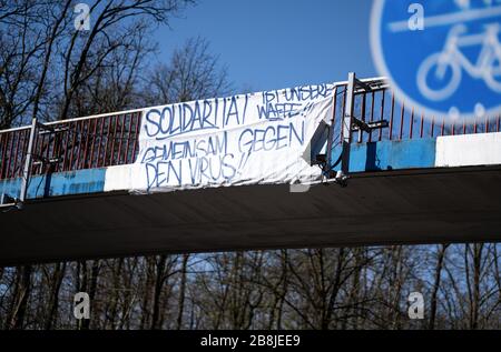 Karlsruhe, Deutschland. März 2020. Ein Banner mit der Aufschrift 'Solidarity ist unsere Waffe, zusammen gegen den Virus!! Hängt an einer Brücke in der Nähe des KSC Wildpark Stadium. GES/Alltag in Karlsruhe während der Coronakrise, 22.03.2020 GES/Alltag während der Coronakrise in Karlsruhe. 22.03.2020 in der Nähe des KSC-Wildparkstadions steht ein Banner auf einer Brücke mit Motivation zur Solidarität gegen das Virus. Weltweite Nutzung Credit: Dpa / Alamy Live News Stockfoto