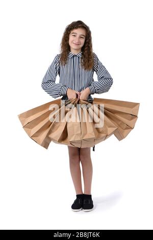 Kind mit einem Paket auf weißem Hintergrund. Kid Happy Shopping in der Mall. Glückliches Mädchen mit langen lockigen Haar. Hochauflösendes Foto. Die volle Tiefe von fi Stockfoto