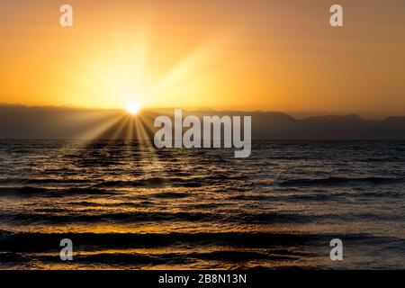 Sonnenaufgang über den Bergen von Saudia Arabien vom Bayview Taba Heights Resort entlang des Roten Meeres, Ägypten, Naher Osten. Stockfoto