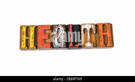 Helath. COVID-19 Coronavirus - Ausbruch des Desease, der zuerst aus Wuhan, China gemeldet wurde. Farbige Holzbuchstaben auf weißem Hintergrund Stockfoto