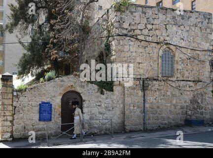 Ein hasidischer jüdischer Mann, der durch das Kinderkrankenhaus des historischen Marienstifts in der Straße Ha-Neviim in Jerusalem spält. Stockfoto