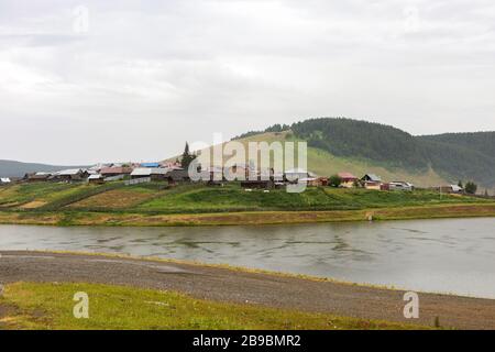 Panoramablick auf das kleine, recht europäische Dorf und die Umgebung, malerisch gelegen am Fuß des Mittelbergs, der mit Wald auf schmalen RI bedeckt ist Stockfoto