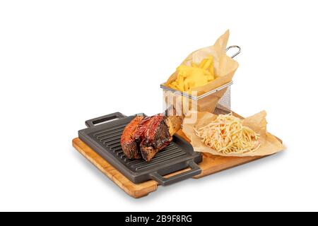 Gegrillte Schweinerippen mit Barbrcue Sauce mit pommes frites und Salat aus Kohl Stockfoto