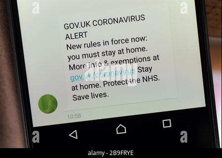 BRITISCHE REGIERUNG CORONAVIRUS WARNT HANDY-TEXTNACHRICHT, DASS SIE ZU HAUSE BLEIBEN MÜSSEN, UM COVID -19-VIRUS UK ZU SPERREN Stockfoto