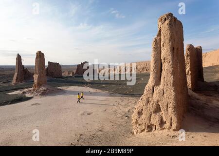 Mutter und Sohn in den atemberaubenden Ruinen der Festung Jampik Kala in der Wüste Kyzylkum in der Region Karakalpakstan in Usbekistan Stockfoto