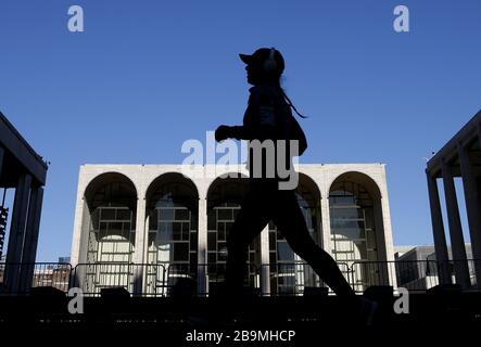 New York, USA. März 2020. Eine Frau jogg am Dienstag, 24. März 2020 im Lincoln Center in New York City. Der Staat New York berichtet von den meisten Fällen und Todesfällen im Land mit mehr als 23.230 bestätigten Fällen und 188 Todesfällen. Foto von John Angelillo/UPI Credit: UPI/Alamy Live News Stockfoto