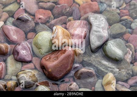 Bunte polierte Steine im Wasser Stockfoto