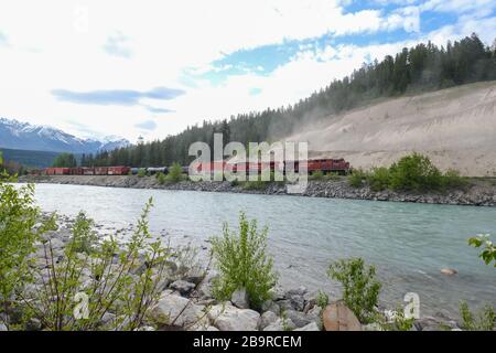 Revelstoke - 21. Mai 2019: Revelstoke, Britisch Kolumbien, Kanada. Güterzug, der sich entlang des Bow River in den kanadischen Rockies, Revelstoke, Britisch bewegt Stockfoto