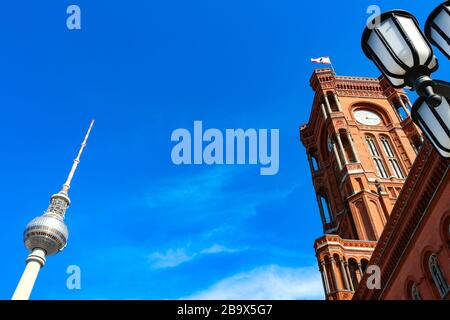 Fernsehturm und Rathaus (deutsch: "Rotes Rathaus") mit schwenkender Berliner Flagge am Alexanderplatz im östlichen Zentrum von Berlin, der Hauptstadt Deutschlands. Stockfoto