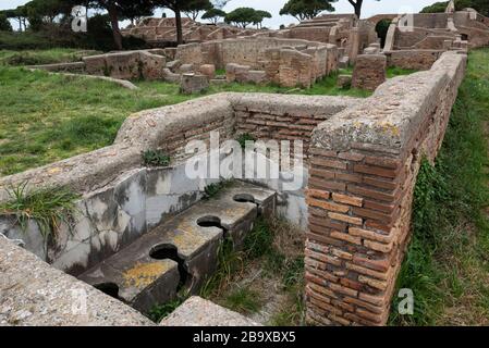 Rom. Italien. Ostia Antica. Überreste der Schola di Traiano (Schola Traianea / Gildensitz Trajan).die Latrine in der Südecke des Gebäudes. Stockfoto