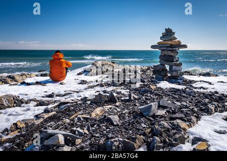 Bild von Mensch und Steinskulptur, die soziale Distanzierung darstellen. Stockfoto