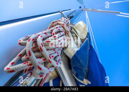 Blauer Himmel. Bodenansicht des Mastes einer Segelyacht. Ein hank Seil und andere Takelage Stockfoto