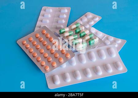 Sechs Blasen generischer Tabletten auf blauem Hintergrund.Pillen in Paketen.diverse Medikation.Pharmazeutische Industrie.Gesundheitswesen und Medizin.psychische Gesundheit. Stockfoto