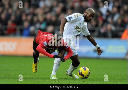 Swansea City kämpfen mit Dwight Tiendalli (rechts) und Ashley Young (links) von Manchester United um den Ball Stockfoto