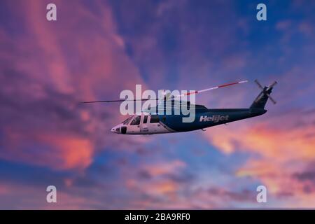 Helijet-Hubschrauber im Flug gegen Sonnenuntergang Sky-Victoria, British Columbia, Kanada. Nicht zusammengesetztes Bild. Stockfoto