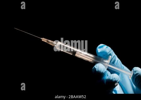 Impfnadel mit Handnaht von glitzten Ärzten. Konzept für das Gesundheitswesen und die Medizin. Nadel bereit, zur Impfung in die Klinik injiziert zu werden. Stockfoto