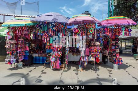 Ojo de dios und andere Handwerkskunst zum Verkauf beim Straßenmarkthändler in Sayulita, Riviera Nyarit, Mexiko. Stockfoto