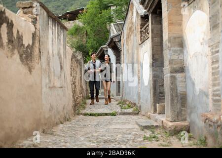 Junges chinesisches Paar, das im Dorf herumläuft Stockfoto
