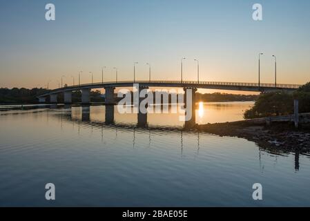 Sonnenaufgang über die singende Brücke, die sich mit den Küstenstädten Tea Gardens und Hawks Nest an der Nordküste von New South Wales in Australien verbindet Stockfoto