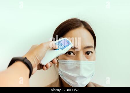 Digitales Thermometer mit Handhaltung zur Messung der Symptome des Coronavirus. Stockfoto