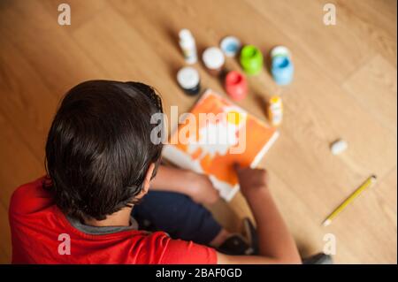 Der junge Junge macht gerne zu Hause Kunsthandwerk Stockfoto