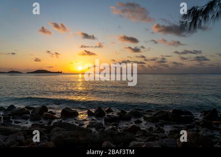 Junge Frauen sitzen am Strand von Anse Petit auf der Insel Mahe Seychellen Stockfoto