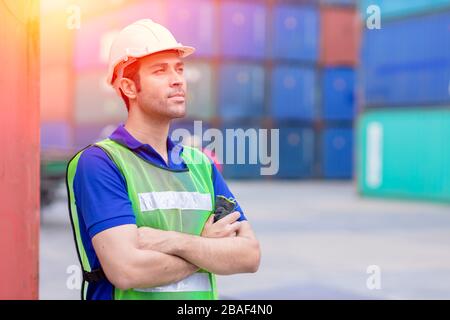 Portrait des Schiffahrtsarbeiters stolz auf die Arbeit im Frachthafen für Import-Export-Waren im stehen. Stockfoto