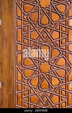 Geometrisches Muster an einer Holztür in der Sehzade-Moschee in Istanbul, Türkei. Islamische Kunst, Holzarbeiten, Details im Detail. Stockfoto