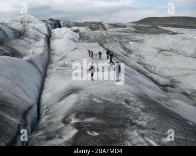 Gletscherwanderungsgruppe von Alpinisten oder Touristen in Island - Svinafellsjökull Glacier im Vatnajökull nationalpark in der Nähe des Skaftafell-Gletschers Stockfoto