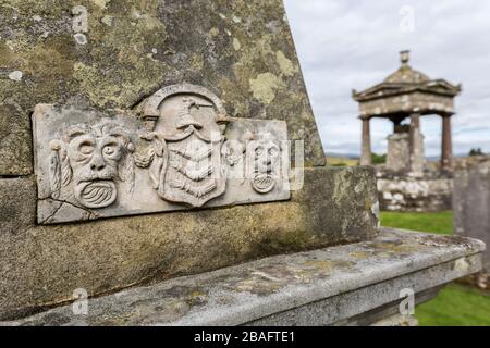 Geschnitzte Gesichter und Wappen auf dem Grabstein des Obelisken, Old Castleton Cemetery, Newcastleton, St Martin's Churchyard, Byerholm, Castleton, Roxburghshire, Scotlan Stockfoto