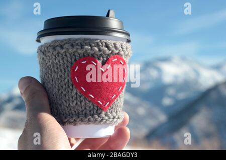 Strickkaffeetasse im roten Herzen, gemütlich Stockfoto