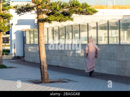 Mann in typisch marokkanischer Kleidung, zu Fuß eine Straßenstadt, Essaouira, Marokko. Rückansicht Stockfoto