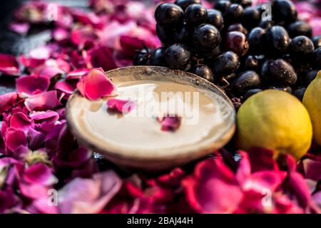 Nahaufnahme der Gesichtsmaske, um die Öligkeit in der Haut auf schwarzer Oberfläche zu schlagen, die aus Traubenbrei, Zitronensaft und Multani Mitti oder Multani Mitti besteht. Stockfoto