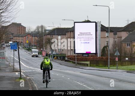 Parkhouse, Glasgow, Schottland, Großbritannien während der Coronavirus Sperrzeit 2020 - nhs-Coronavirus Informationsschild, das die viel ruhigere Straße dominiert Stockfoto