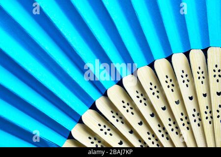 Detail der offenen blauen faltbaren Handventilator. Ein Ventilator sorgt im Sommer für Kühlluft. Stockfoto