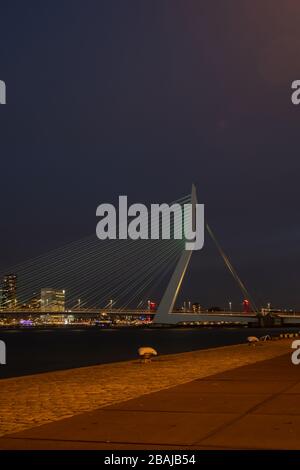 Rotterdam - 12. Februar 2019: Rotterdam, die Skyline der niederländischen Innenstadt in der Dämmerung in Südholland, Rotterdam, Niederlande. Rechts die Erasmus-Brücke Stockfoto