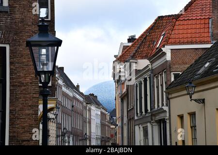 Zwolle, die Netherlands-Februar 2020: Sehen Sie sich durch den Blick auf eine der alten Straßen von Zwolle mit dem ikonischen eiförmigen Dach, das sich am äußersten Ende abzeichnet Stockfoto