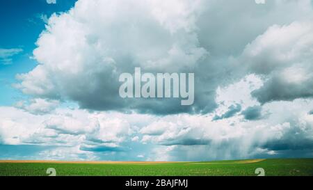 Wundervoller Natürlicher, Heller, Dramatischer Himmel Mit Regenwolken Über Dem Land Ländliche Feld-Wiese Landschaft Im Frühling Sommer Bewölkt Tag. Malerischer Himmel Mit Flusen Stockfoto