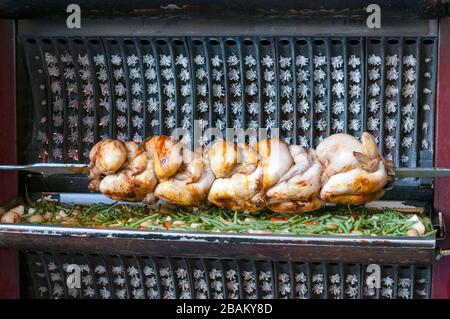 Rotisserie Huhn und Kartoffeln in der Nähe des Eingangs eines Einheimischen in Paris Stockfoto