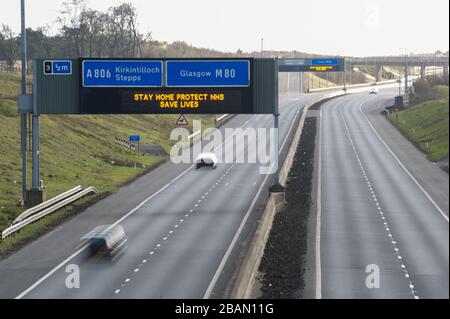 Glasgow, Großbritannien. März 2020. Abgebildet: Straßenschilder auf den Autobahnen M8 und M80, die lauten: "BLEIBEN SIE ZU HAUSE SCHÜTZEN Sie NHS RETTEN SIE LEBEN" die Pandemie von Coronavirus hat die britische Regierung gezwungen, eine Abschaltung aller britischen Großstädte anzuordnen und die Menschen zu Hause zu lassen. Das hat die Autobahnen und alle anderen Straßen frei von der üblichen Nase gelassen, um den Verkehr, der sonst da wäre, zu vereitelen. Kredit: Colin Fisher/Alamy Live News Stockfoto