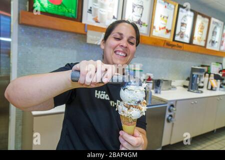 Miami Beach, Florida, Haagen Dazs, Eis, hispanische Frau weibliche Erwachsene Erwachsene, Aushöhlungen, Schaufeln, Kegel, Arbeiten, Arbeiten, Angestellte Arbeiter Personal, FL11 Stockfoto