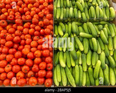 Großer Haufen roter Tomaten und frischer Gurken auf dem Hypermarkt Stockfoto