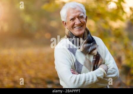 Glücklicher Senior im Herbstpark Stockfoto