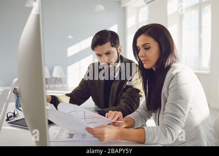 Seriöse Geschäftsleute diskutieren die Analyse der Arbeit, die am Tisch im Büro sitzt Stockfoto