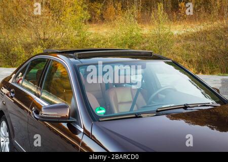 Mercedes Benz W204-Innenraum mit Vorder- und Rücksitzen, Fahrer und Beifahrer, Teil vom Lenkrad, Vorhang hinten, braunes Leder, Stockfoto