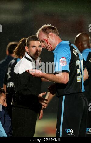 Wycombe Wanderers Gary Doherty erhält Behandlung für einen blutigen Kopf Stockfoto