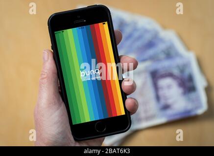 Eine Frau, die die bunq Bank App auf einem Handy verwendet. (Nur Redaktionelle Verwendung) Stockfoto