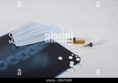 Röntgenaufnahme der Lunge, chirurgische medizinische Maske und Medikamente auf weißem Hintergrund, Pneumonie und Bronchitis Konzept. Virusinfektion. Stockfoto