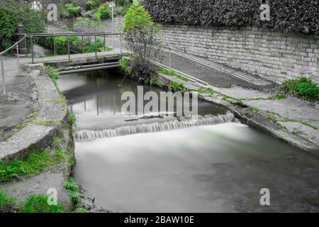 Lange Exposition eines Wasserfalles auf dem Lim Steg am Lyme Regis in Dorset. Stockfoto